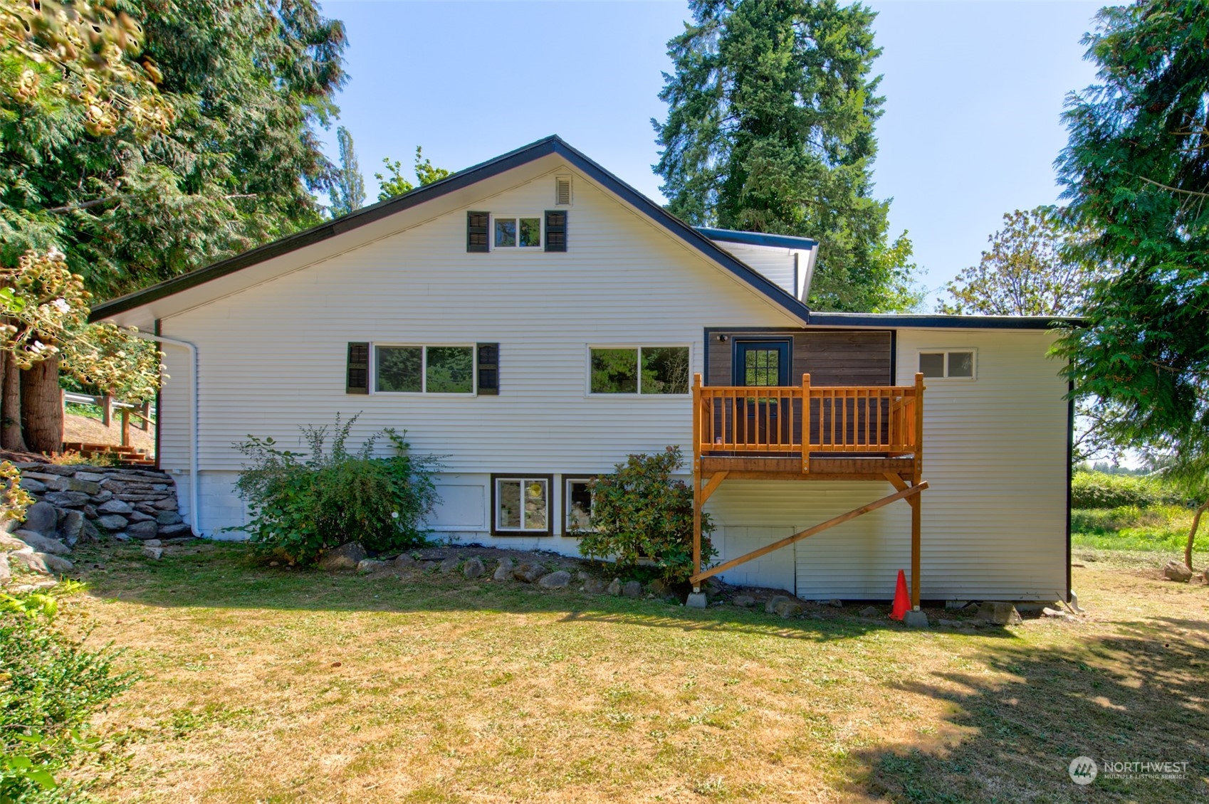 17315 Southeast May Valley Road Renton, WA 98059 - Photo 3 of 25 a view of a house with backyard and trees