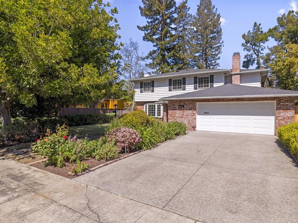 a front view of a house with a yard and a garage