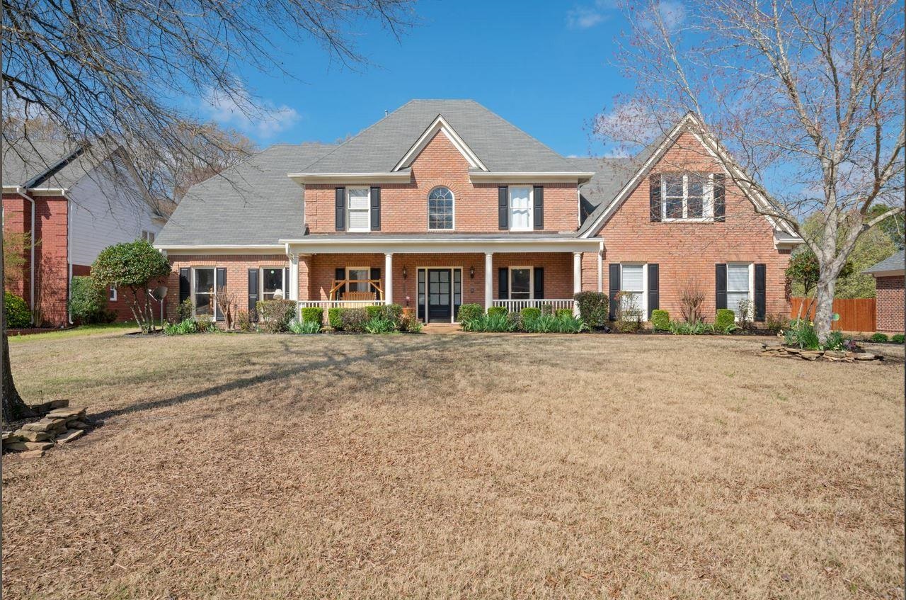1385 Winoka Road Collierville, TN 38017 - Photo 1 of 16 a front view of a house with a garden