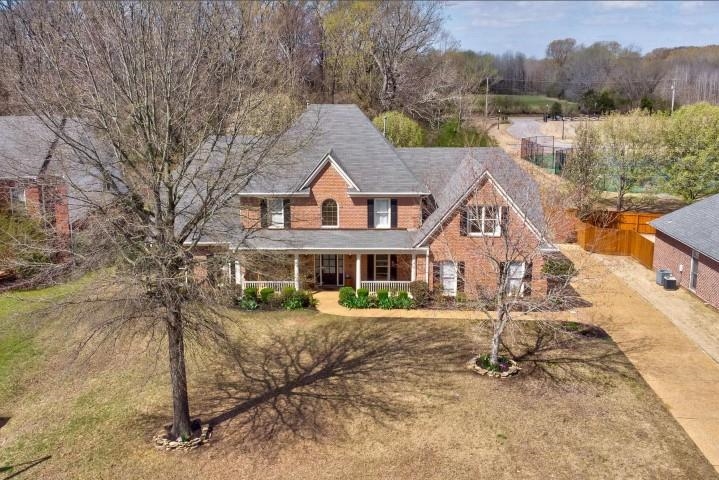1385 Winoka Road Collierville, TN 38017 - Photo 14 of 16 a front view of a house with a yard and garage
