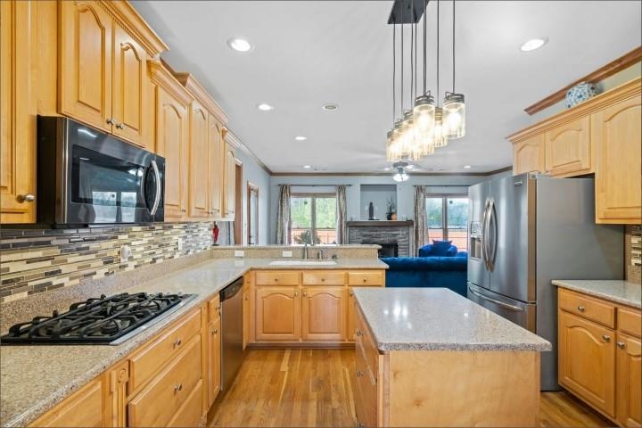 1385 Winoka Road Collierville, TN 38017 - Photo 6 of 16 a large kitchen with stainless steel appliances granite countertop a lot of counter space and wooden floor