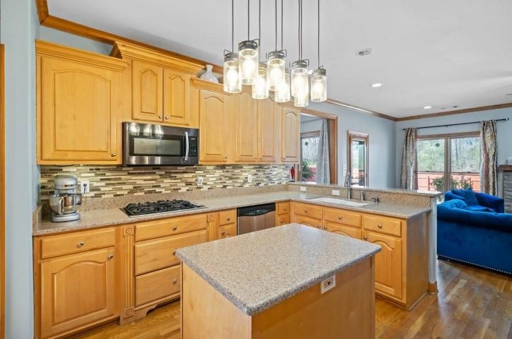 1385 Winoka Road Collierville, TN 38017 - Photo 7 of 16 a kitchen with stainless steel appliances granite countertop a sink dishwasher stove and oven with wooden floor