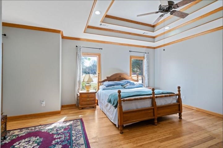 1385 Winoka Road Collierville, TN 38017 - Photo 9 of 16 a bedroom with a bed and wooden floor