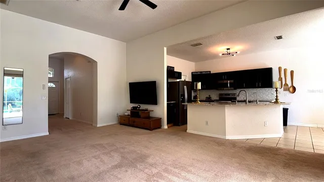 a view of living room kitchen with furniture and flat screen tv