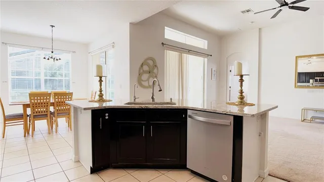 a kitchen with a sink and chairs