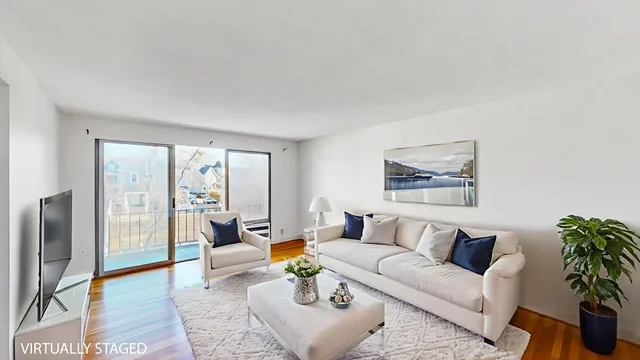 a living room with furniture and a floor to ceiling window