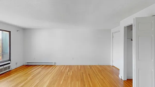 a view of an empty room and wooden floor