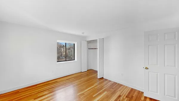 a view of a room with wooden floor and closet