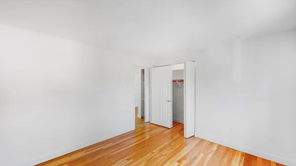a view of room with wooden floor