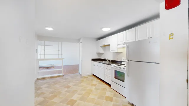 a kitchen with stainless steel appliances a refrigerator sink and stove
