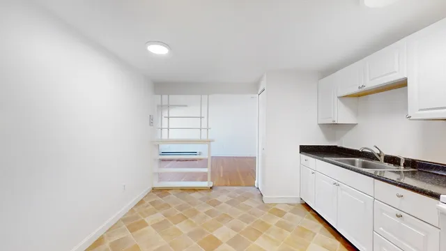 a kitchen with a sink and cabinets