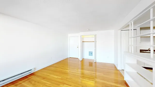 a view of a room with wooden floor and pool table and chair