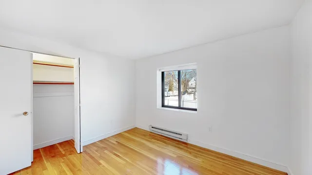 a view of a room with wooden floor and closet
