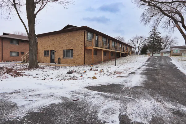 a view of house covered with snow in front of house