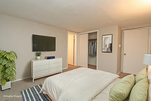 a bedroom with a bed and a flat screen tv