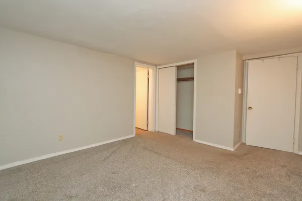 a view of an empty room and closet area