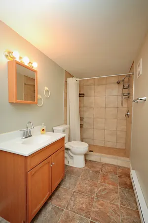 a bathroom with a sink toilet and shower