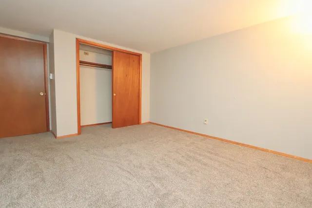 an empty room with closet area