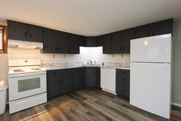 a kitchen with stainless steel appliances a refrigerator sink and cabinets