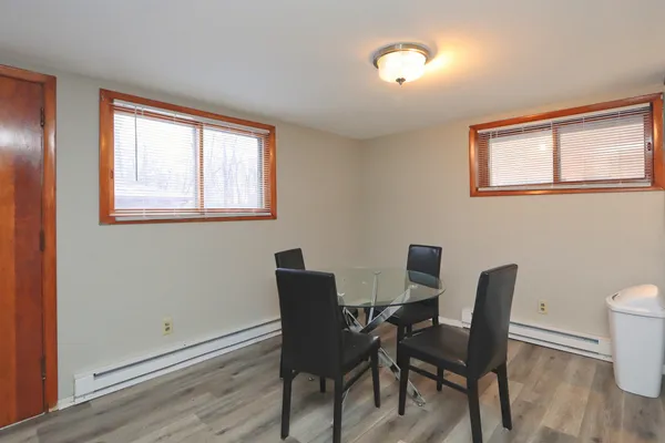a view of a dining room with furniture and wooden floor