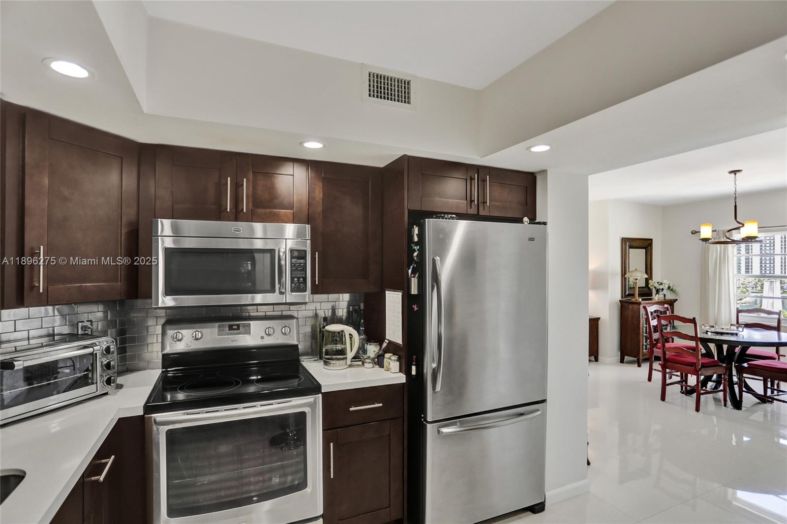 500 Bayview Drive, Unit 731 Sunny Isles Beach, FL 33160 - Photo 11 of 46 a kitchen with a refrigerator stove and microwave