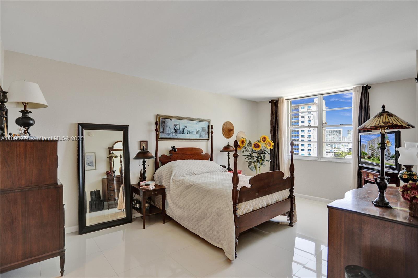 500 Bayview Drive, Unit 731 Sunny Isles Beach, FL 33160 - Photo 21 of 46 a bed room with a bed and paintings on the wall