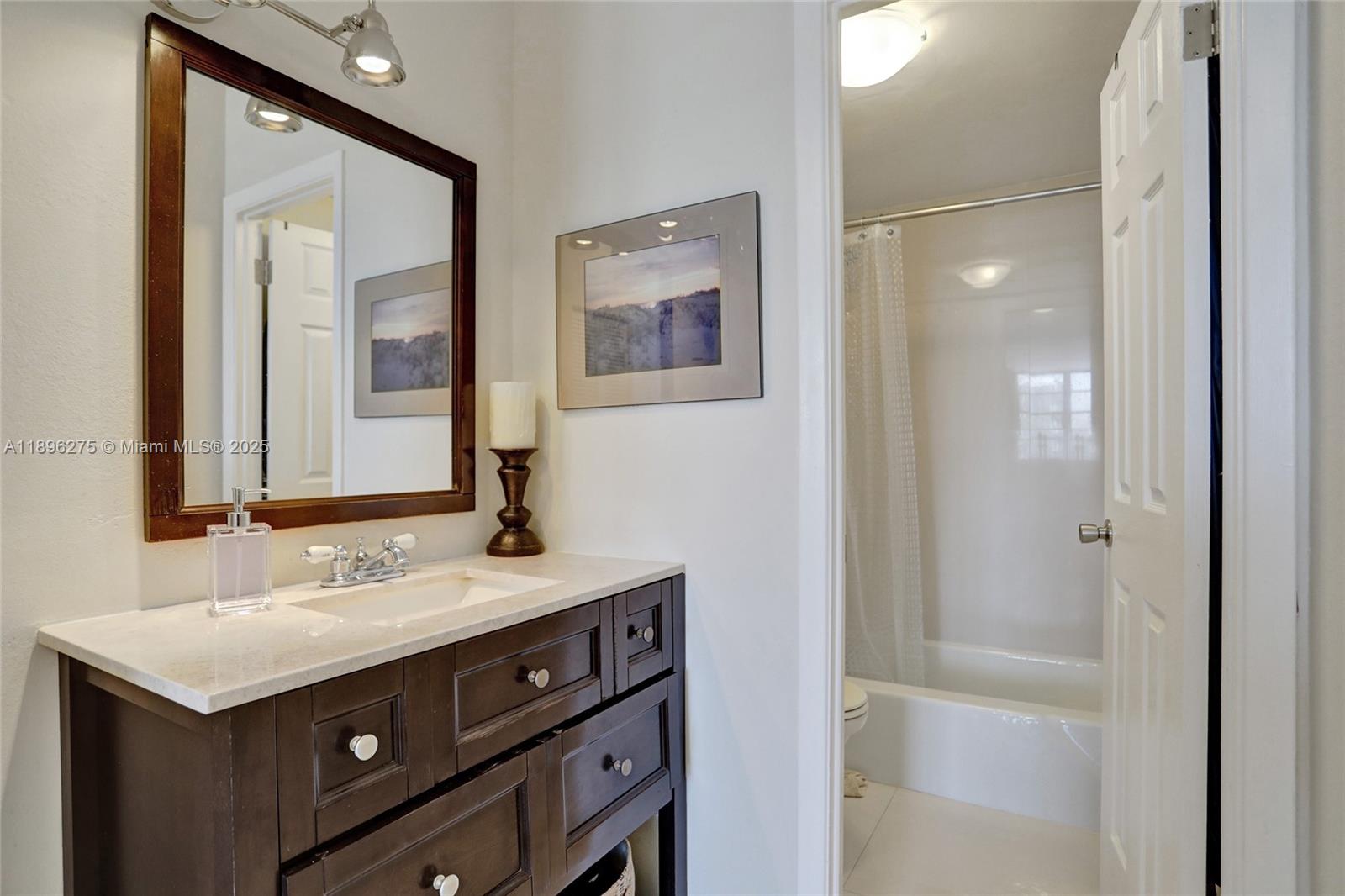 500 Bayview Drive, Unit 731 Sunny Isles Beach, FL 33160 - Photo 25 of 46 a bathroom with a sink and a mirror