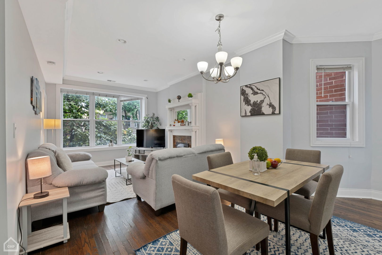 3824 North Clark Street Chicago, IL 60613 - Photo 4 of 16 a view of a dining room with furniture a chandelier and wooden floor