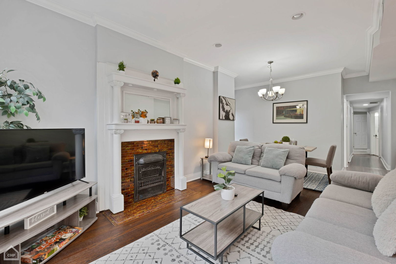 3824 North Clark Street Chicago, IL 60613 - Photo 5 of 16 a living room with furniture a flat screen tv and a fireplace