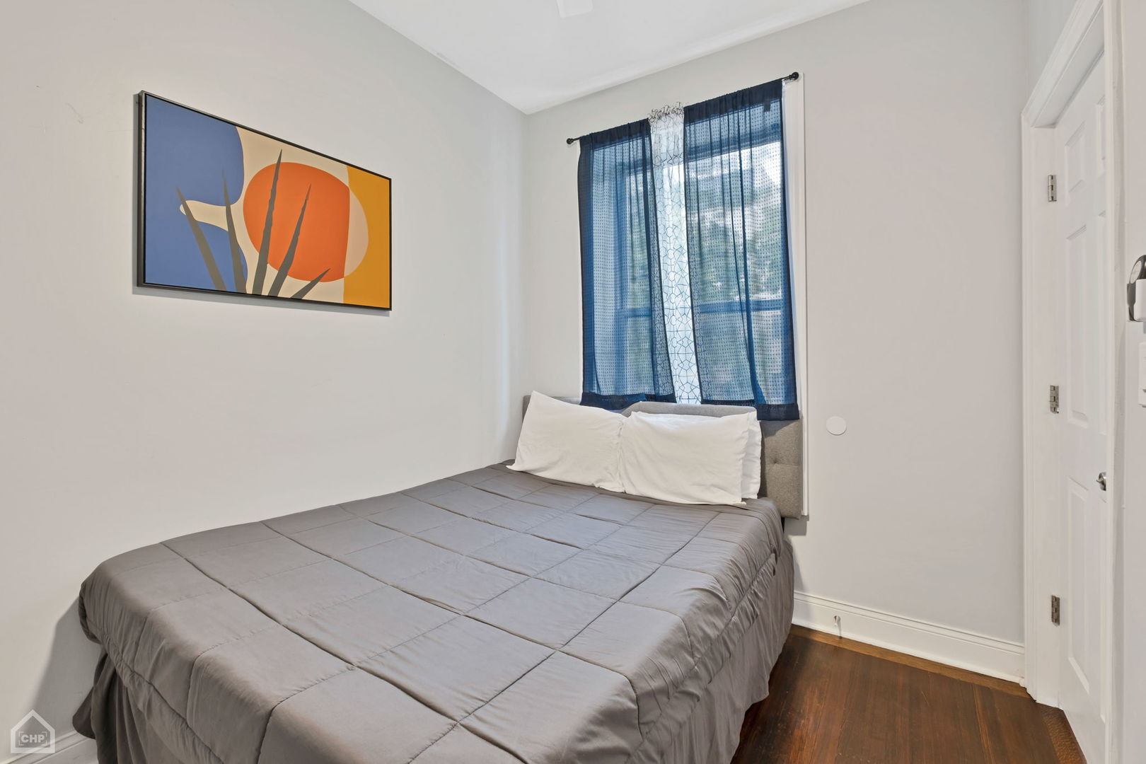 3824 North Clark Street Chicago, IL 60613 - Photo 6 of 16 a bedroom with a bed and a painting on the wall