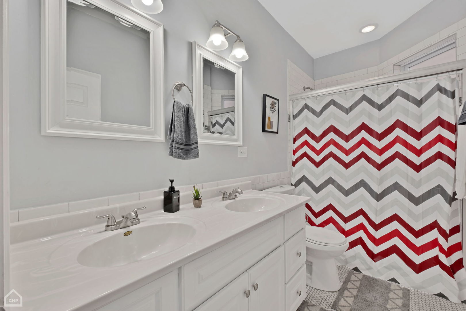 3824 North Clark Street Chicago, IL 60613 - Photo 7 of 16 a bathroom with a sink and a mirror