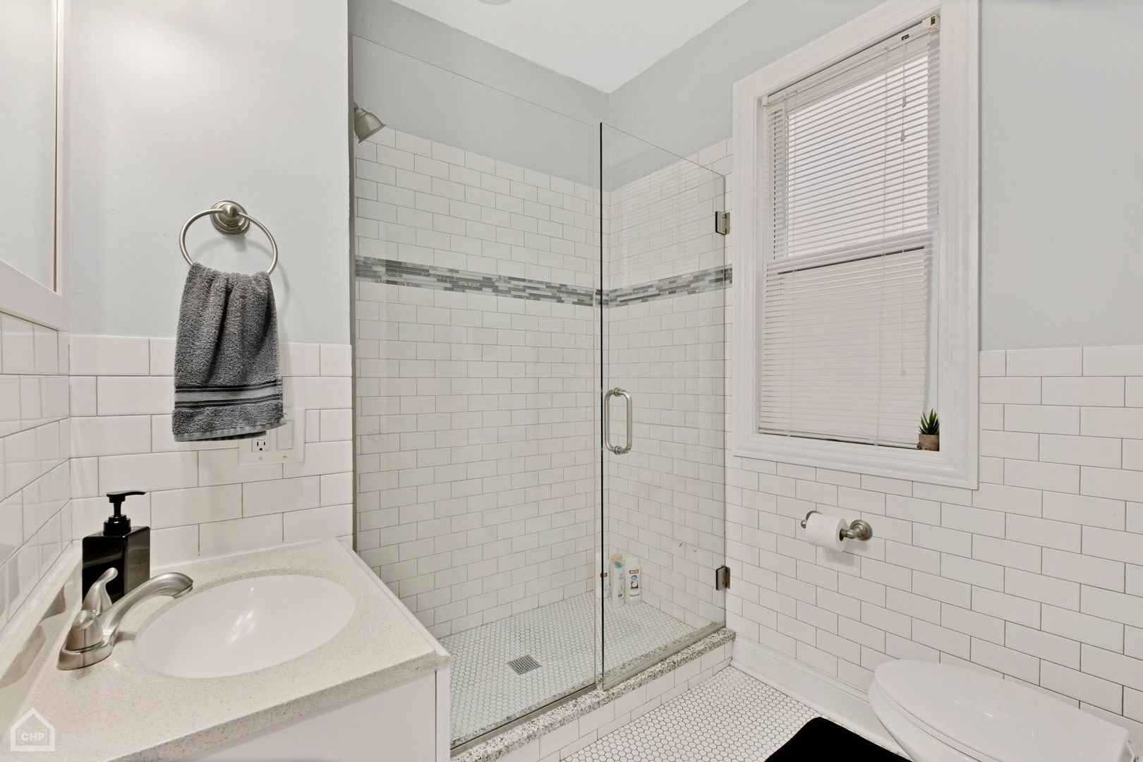 3824 North Clark Street Chicago, IL 60613 - Photo 9 of 16 a bathroom with a sink and a shower