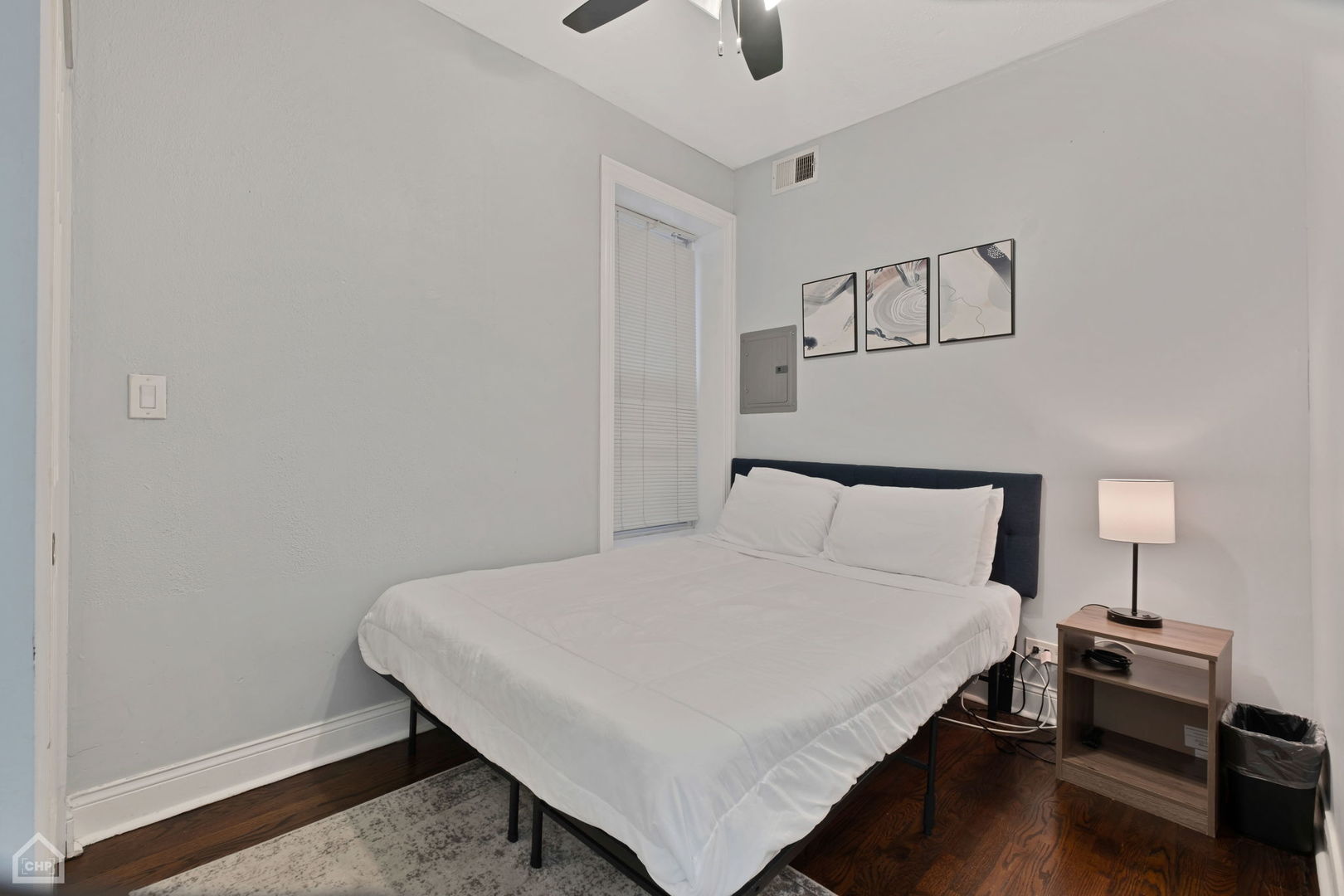 3824 North Clark Street Chicago, IL 60613 - Photo 10 of 16 a bedroom with a bed and a night stand