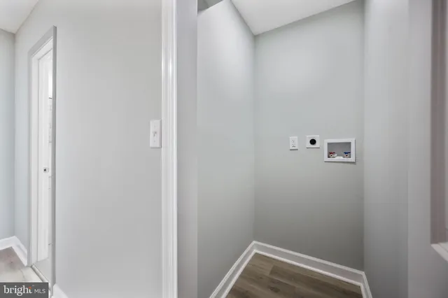 a view of hallway with wooden floor