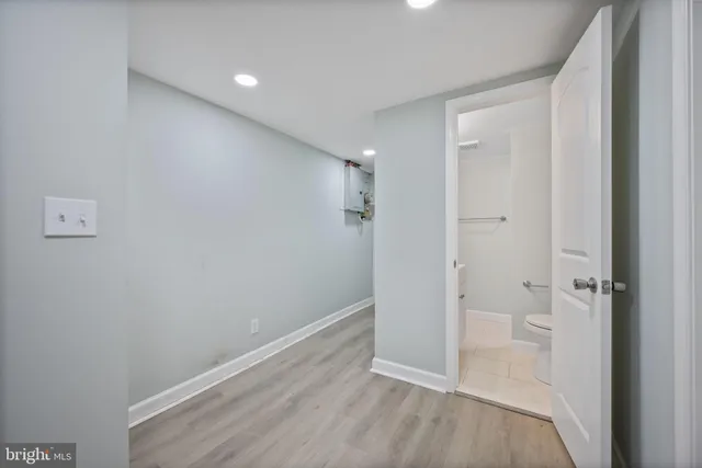 a picture of a room with a white wall and a large window