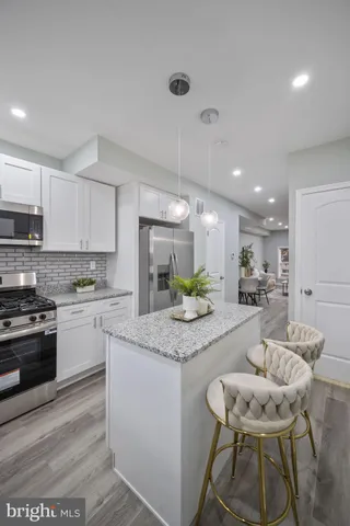 a view of kitchen with cabinets and wooden floor