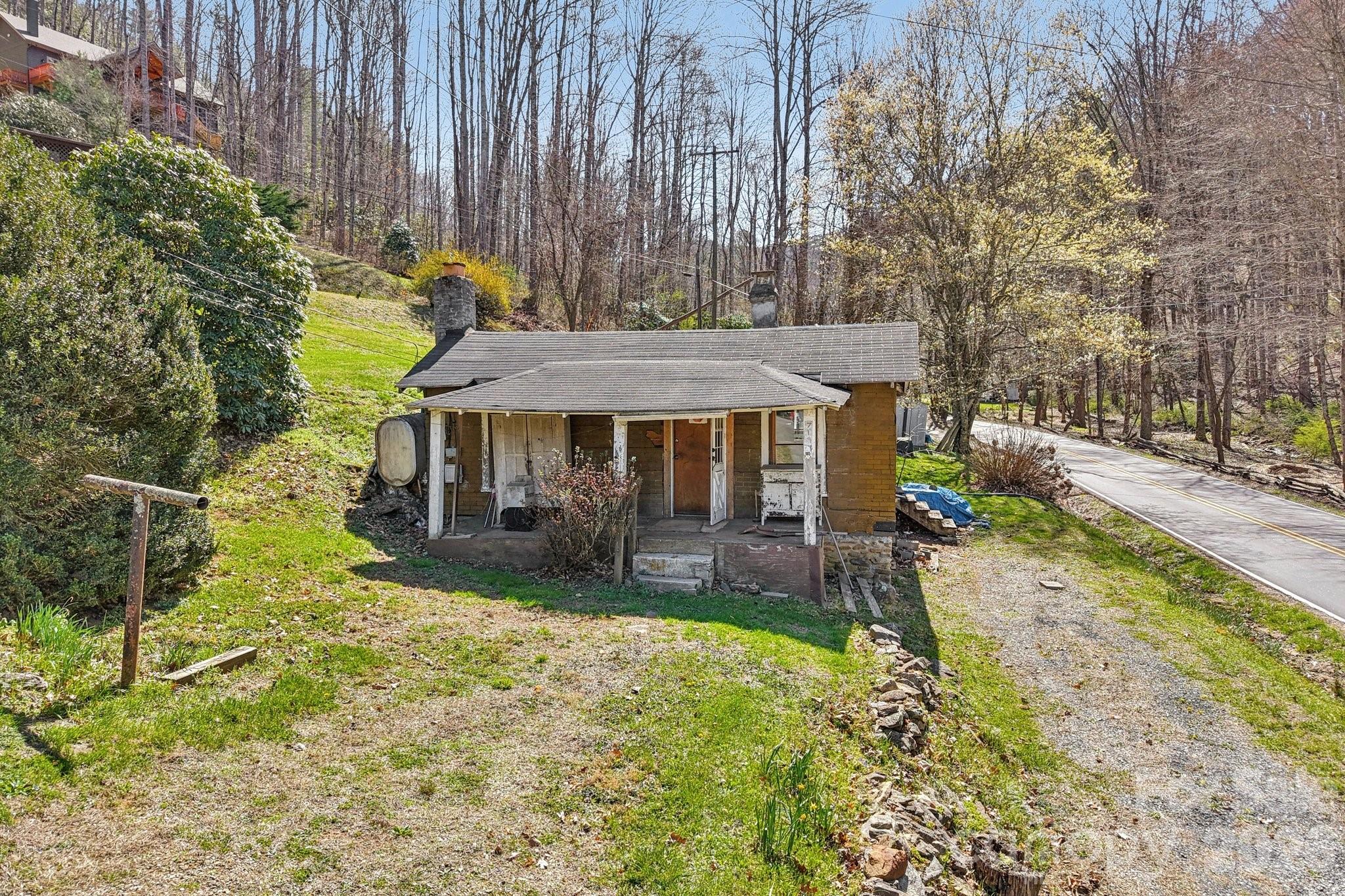 719 Camp Branch Road Waynesville, NC 28786 - Photo 1 of 22 a view of a house with backyard and sitting area