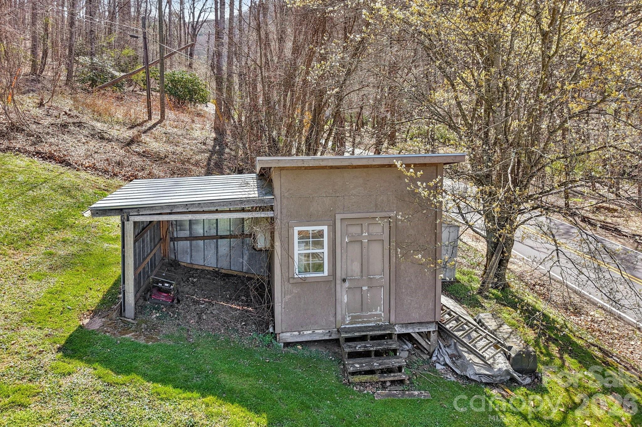 719 Camp Branch Road Waynesville, NC 28786 - Photo 4 of 22 a view of backyard with a barn and a large tree