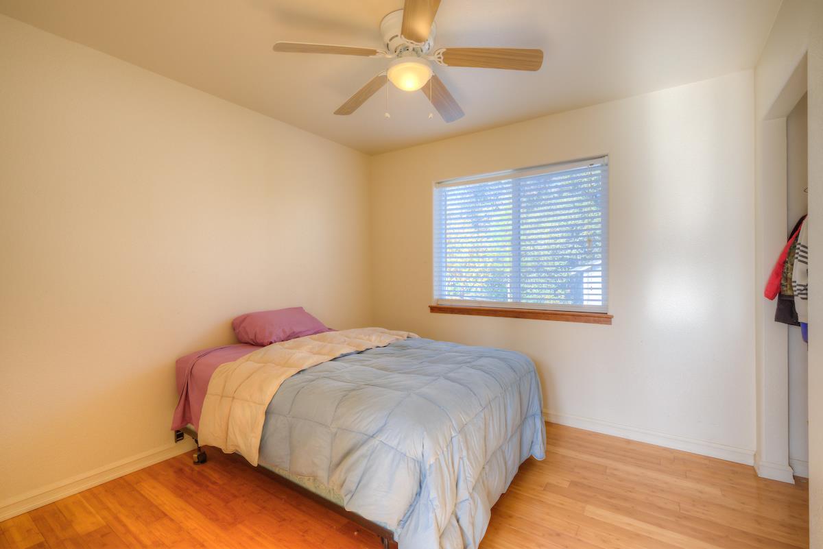 83 Northfork Road Berry Creek, CA 95916 - Photo 17 of 56 a bedroom with a bed and a chandelier