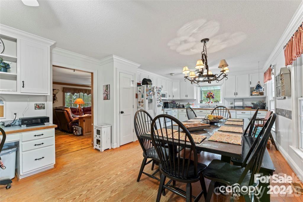 10560 Lake Royalle Road Spring Hope, NC 27882 - Photo 12 of 37 a view of a dining room with furniture and chandelier