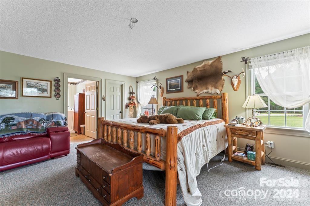 10560 Lake Royalle Road Spring Hope, NC 27882 - Photo 14 of 37 a bedroom with furniture and a window