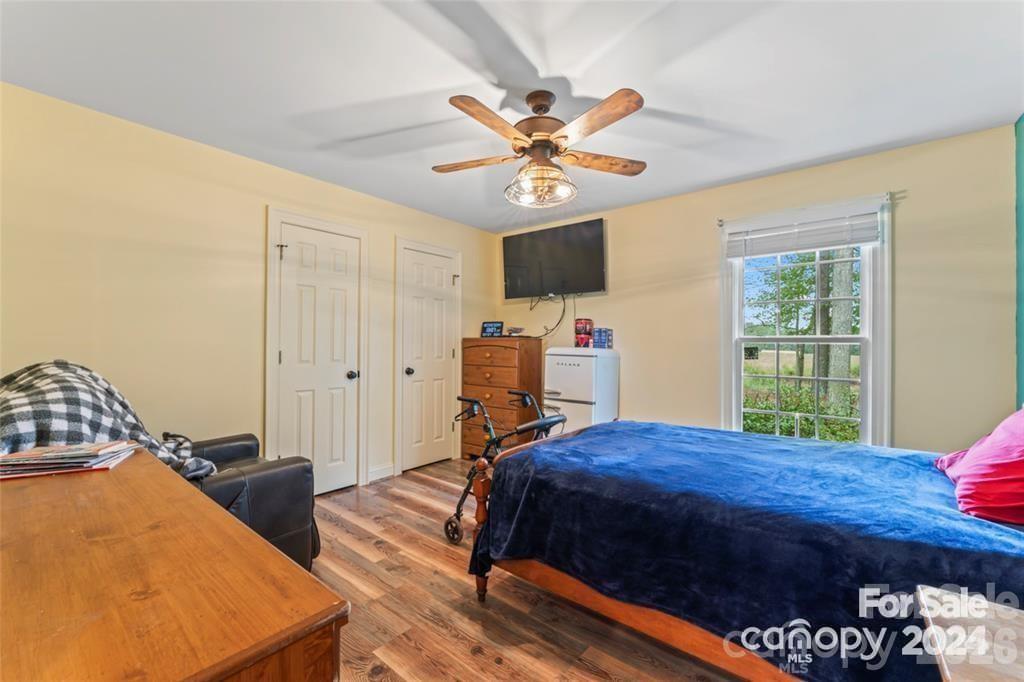 10560 Lake Royalle Road Spring Hope, NC 27882 - Photo 17 of 37 a bedroom with a bed and a chandelier