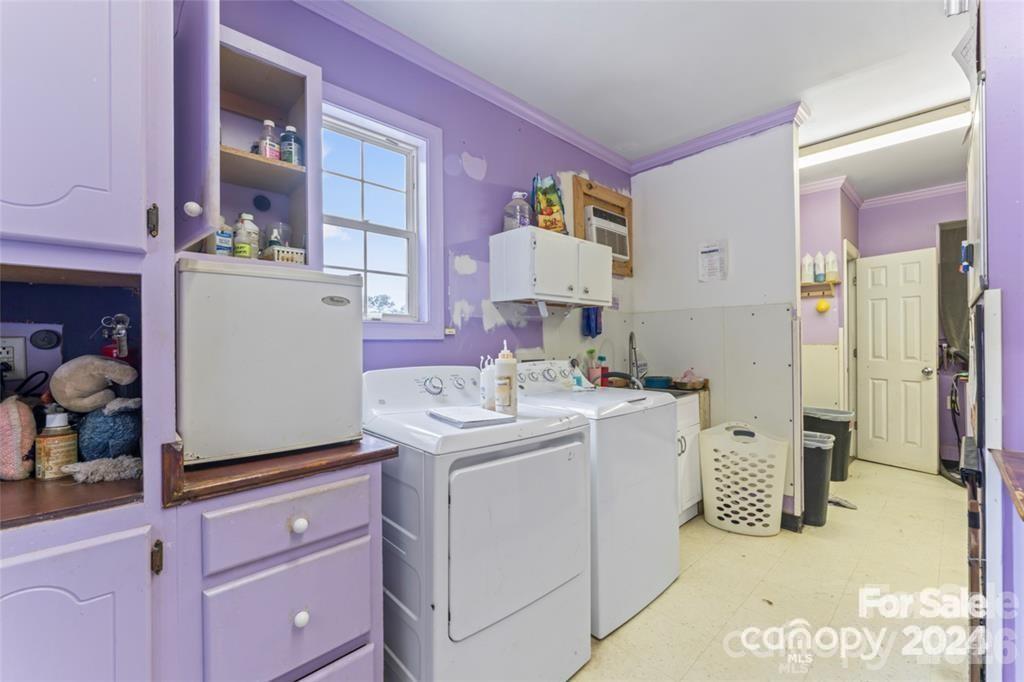 10560 Lake Royalle Road Spring Hope, NC 27882 - Photo 21 of 37 a utility room with cabinets washer and dryer