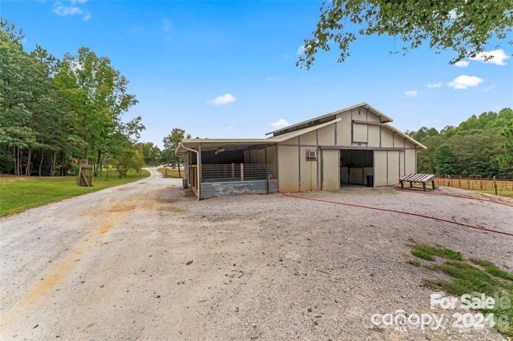 10560 Lake Royalle Road Spring Hope, NC 27882 - Photo 25 of 37 a view of a house with backyard and a tree