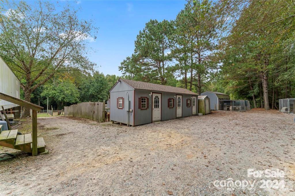 10560 Lake Royalle Road Spring Hope, NC 27882 - Photo 35 of 37 a house with trees in front of it