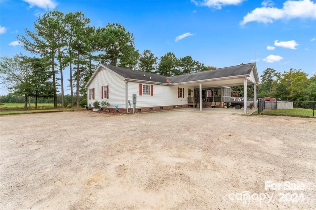 10560 Lake Royalle Road Spring Hope, NC 27882 - Photo 4 of 37 a view of a house with a yard and large tree