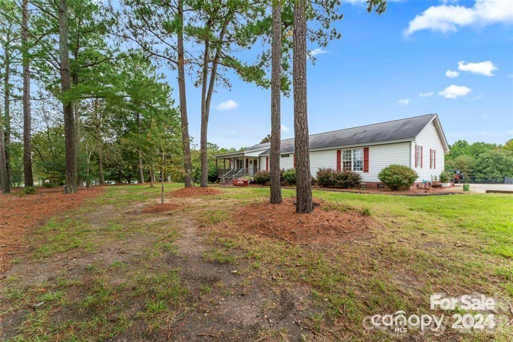 10560 Lake Royalle Road Spring Hope, NC 27882 - Photo 5 of 37 a view of a house with backyard and trees
