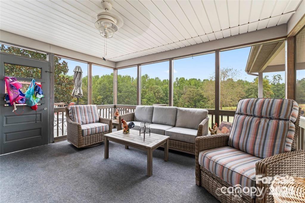 10560 Lake Royalle Road Spring Hope, NC 27882 - Photo 6 of 37 a living room with furniture and a flat screen tv