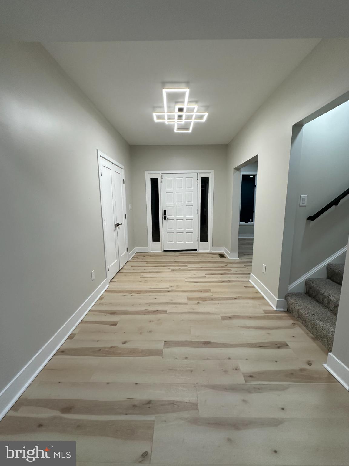 11530 Magnolia Court Issue, MD 20645 - Photo 11 of 31 a spacious bedroom with a bed and a chandelier