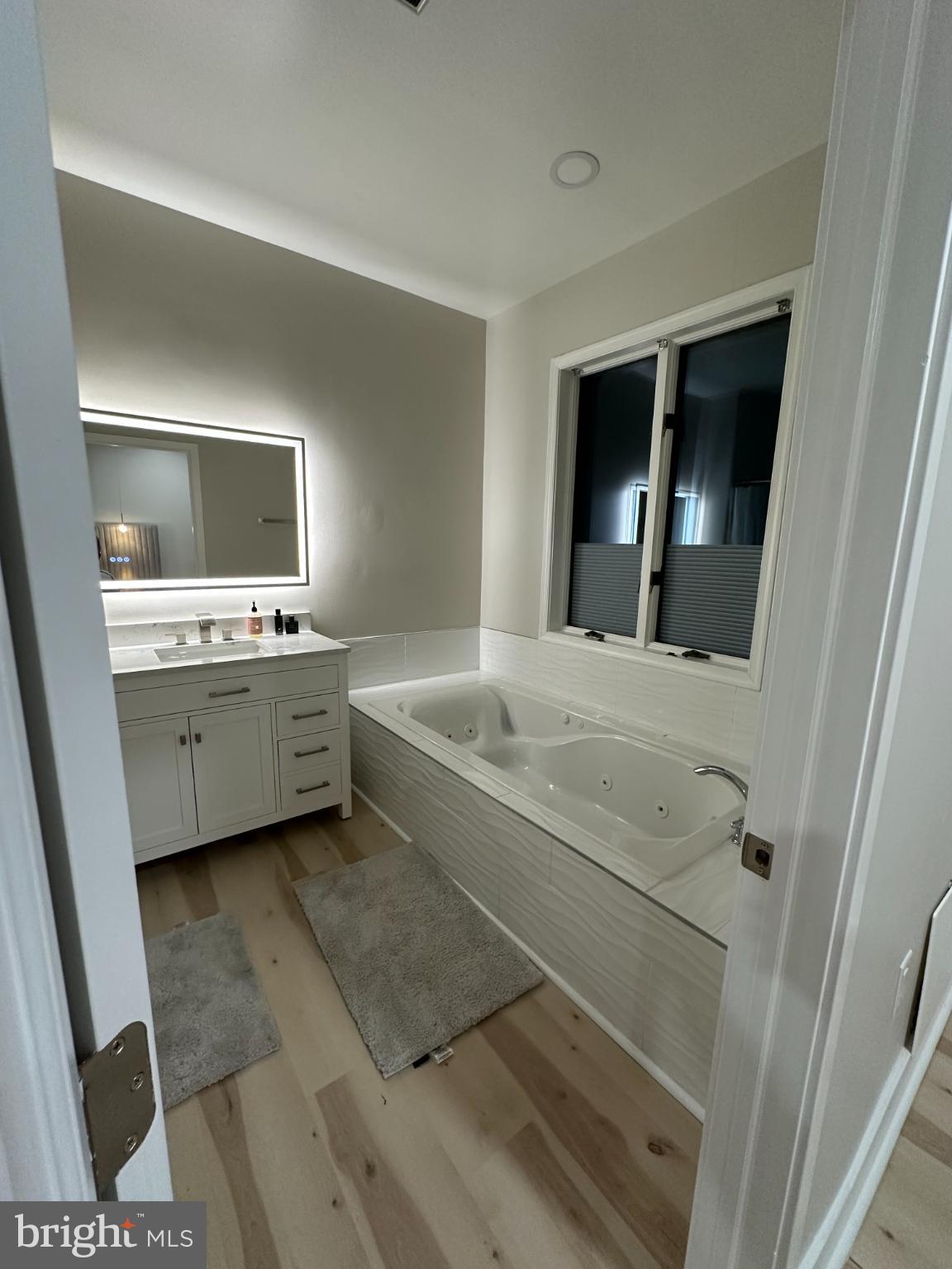 11530 Magnolia Court Issue, MD 20645 - Photo 14 of 31 a bathroom with a double vanity sink and mirror